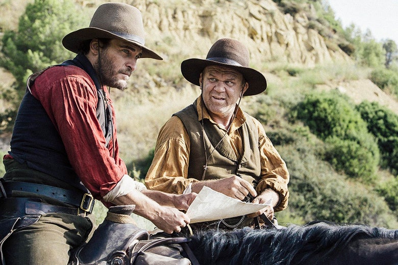 Joaquin Phoenix and John C. Reilly, both on horseback, in a still from the film.